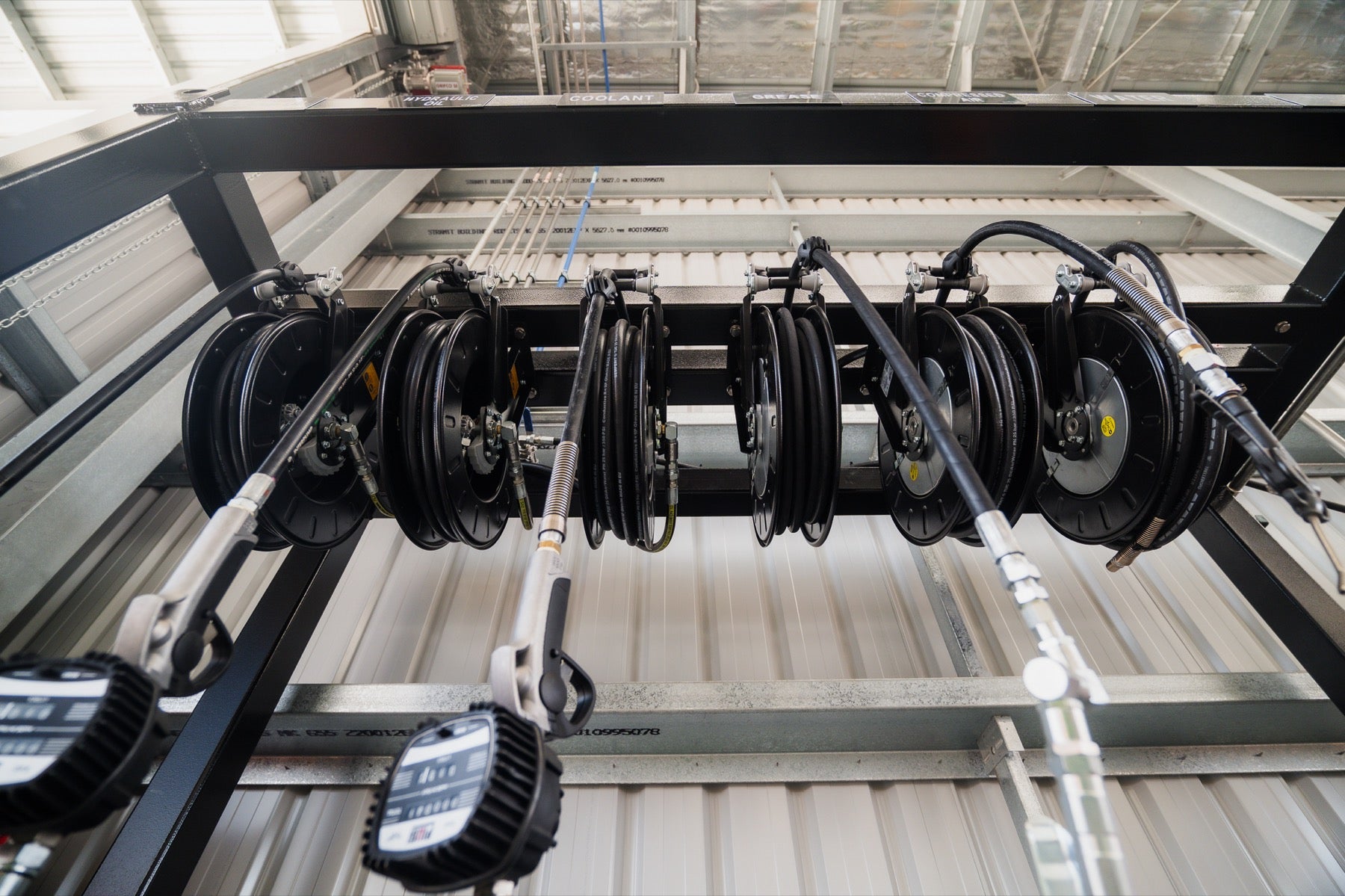 Bank of Piusi spring-rewind hose reels